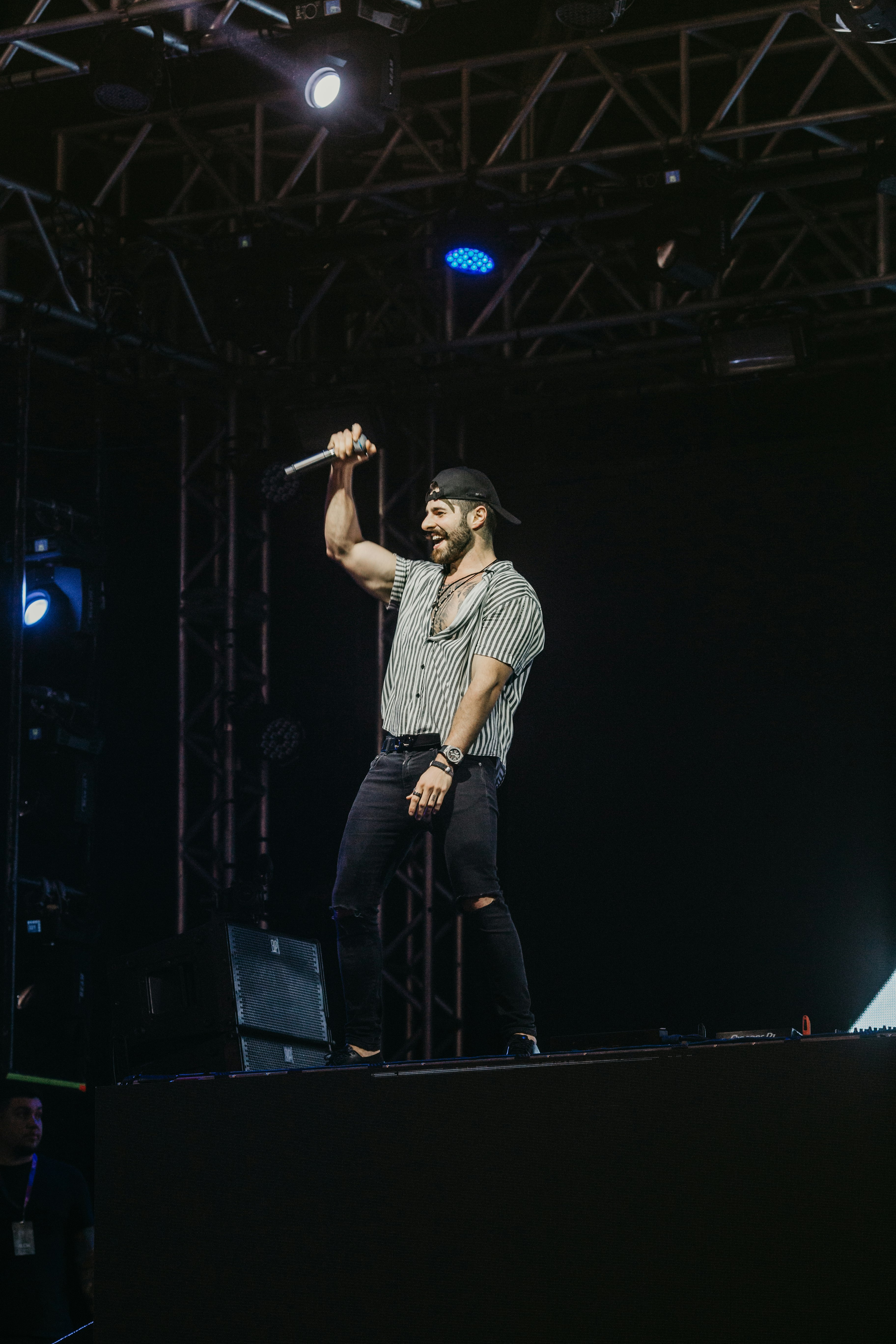 man in gray t-shirt standing on stage